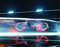 Abstract composition of glowing orange and blue light streaks against a dark background.