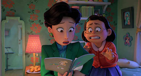 Two animated women with wide eyes and open mouths look down at an open book in a floral-patterned room.