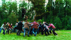 A group of people standing together in a lush, green forest setting.
