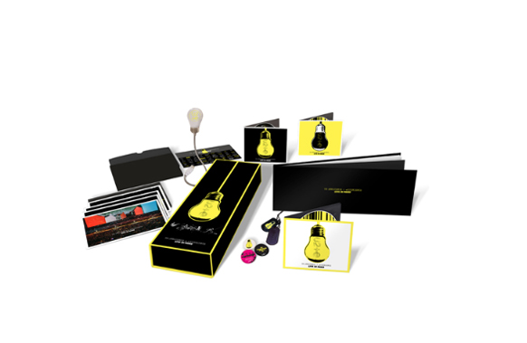 Various black and yellow branded items, including a box, cards, and a lightbulb, arranged on a white background.