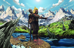 A person in tribal clothing and a golden headpiece stands before snow-capped mountains and a river.
