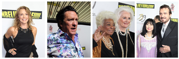 Four individuals pose for photos on a red carpet. A woman in a black dress, a man in a floral shirt, two women with white hai