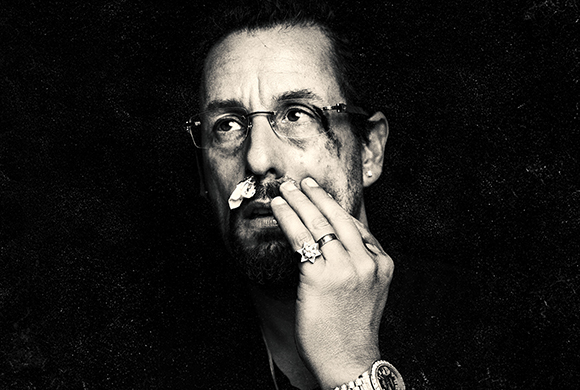Black and white close-up portrait of a man wearing glasses with a small white flower tucked in his nostril.