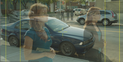 Double exposure of a woman overlaid on a blue car parked on a city street.