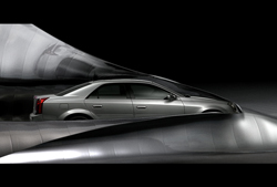 A silver sedan partially covered by large, sweeping waves of dark, metallic fabric against a black background.