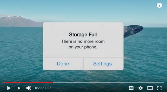A smartphone notification reading 'Storage Full' over a video of a whale in blue ocean water.