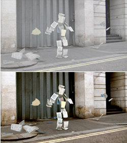 Papers flying in the air to form the silhouette of a person walking on a city street.