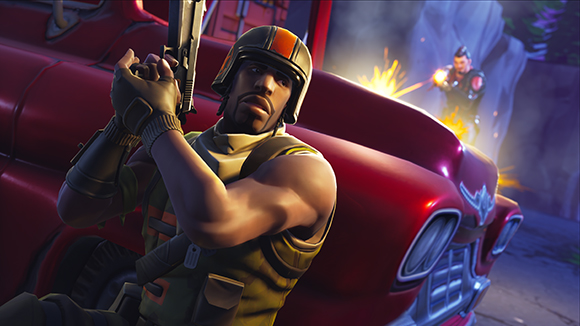 A soldier in a helmet holds a weapon behind a red car as another character fires in the background.