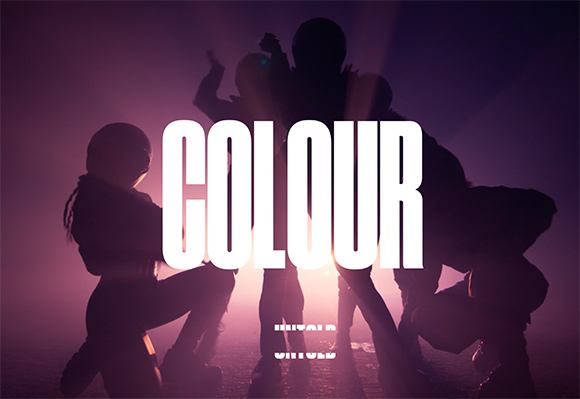 Silhouettes of people posing in a purple-lit haze behind large white text reading COLOUR.