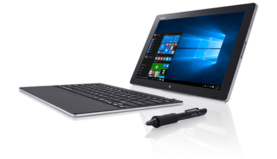 A silver tablet displaying Windows 10, a detached keyboard, and a black stylus on a white surface.