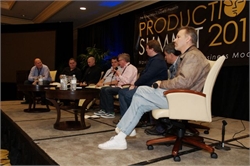 Six men sit in chairs on a stage during a presentation at the Production Summit 201.
