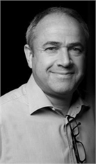 Black and white portrait of a middle-aged man with short hair wearing a collared shirt.