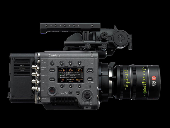 A black CineAlta digital cinema camera equipped with a large 35mm lens and top handle against a black background.