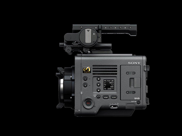 Side view of a professional Sony cinema camera with a top handle and lens mounted.