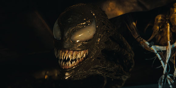 A dark, slimy creature with large white eyes and a mouth full of sharp, jagged teeth.