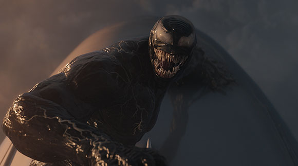 A muscular, black, oily-skinned creature with large white eyes and sharp teeth snarls against a dark sky.