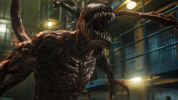 A large, dark red, muscular creature with an open mouth full of sharp teeth and long, spindly limbs.