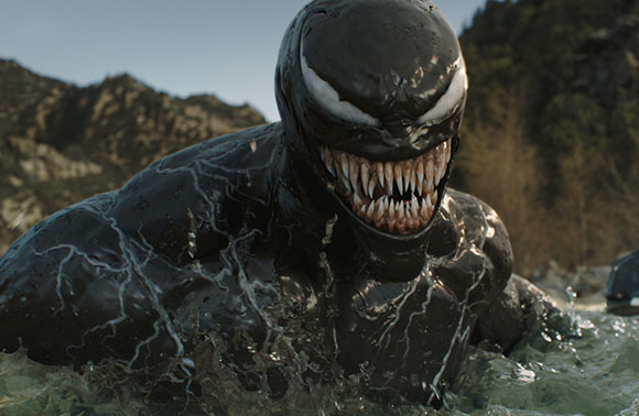 A muscular black creature with large white eyes and sharp teeth emerges from splashing water.
