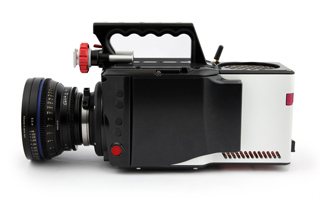 A black and white professional cinema camera with a large lens and top handle against a white background.