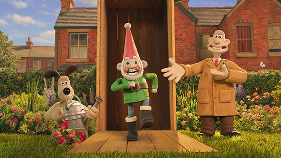 Claymation characters including a gnome, a dog with a watering can, and a man in a tan coat.