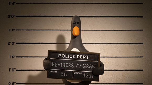 A claymation penguin holding a sign that reads 'POLICE DEPT FEATHERS MCRAW' against a height chart background.