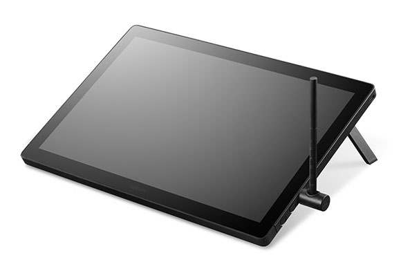 A black digital drawing tablet angled on a white background with a stylus resting against it.