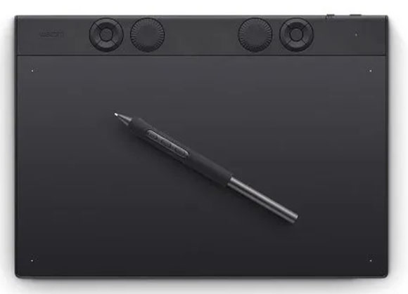A black Wacom graphics tablet with a digital stylus resting on its surface.