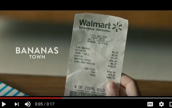 A hand holds a long Walmart receipt showing various items and prices.