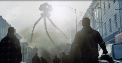 A massive three-legged tripod robot emerges through smoke in a city street viewed from behind several people.