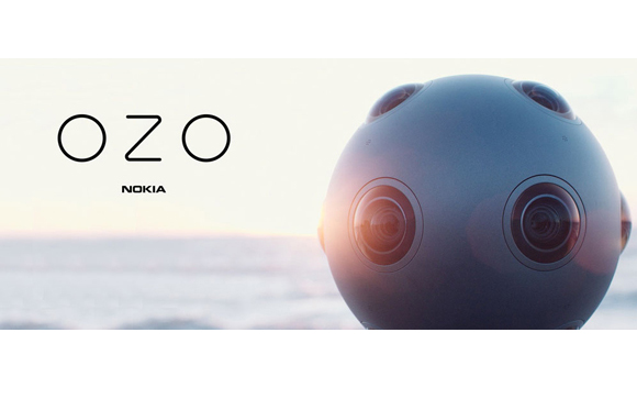 A spherical Nokia OZO camera with multiple lenses sits against a blurred sunset ocean background.