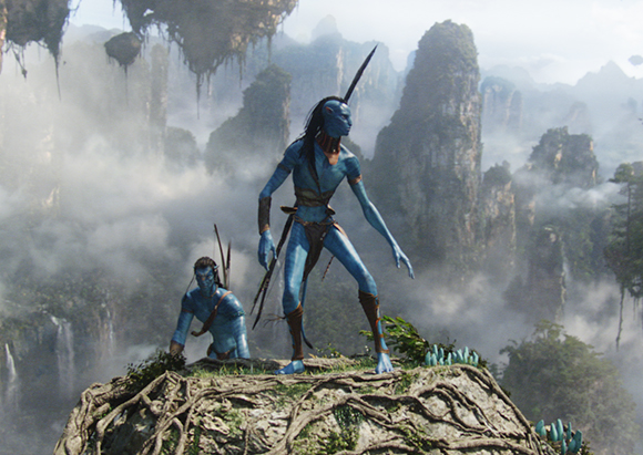 Two blue-skinned humanoid figures stand on a rocky ledge overlooking a misty landscape of floating mountains.