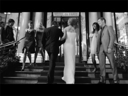 Black and white shot of people in formal wear on the steps of the Hotel de Paris.