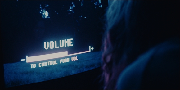 A digital volume bar on a dark screen with text reading 'VOLUME' and 'TO CONTROL PUSH VOL'.