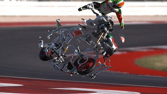 A white motorcycle disintegrating into numerous mechanical parts while mid-air on a racing track.