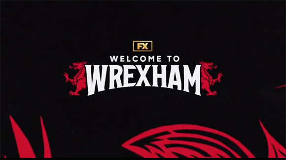 FX logo above the text Welcome to Wrexham flanked by two red dragons on a black background.