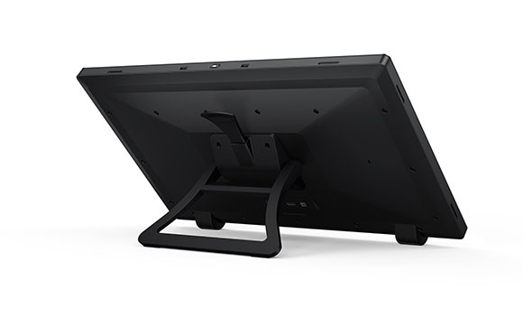 The rear view of a black flat-screen monitor resting on a black U-shaped stand against a white background.
