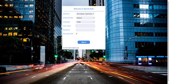 A login window for Xytech Dash centered over a night city street with light trails.