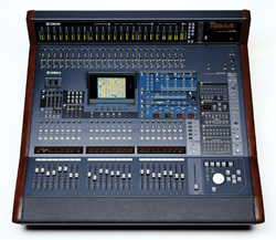 A professional Yamaha digital audio mixing console with numerous faders, buttons, and a central display screen.