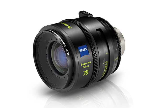A black Zeiss Supreme Prime 35mm cinema lens angled on a white reflective surface.