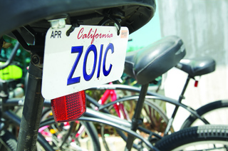 Close-up of a bicycle seat with a white California license plate that reads ZOIC.