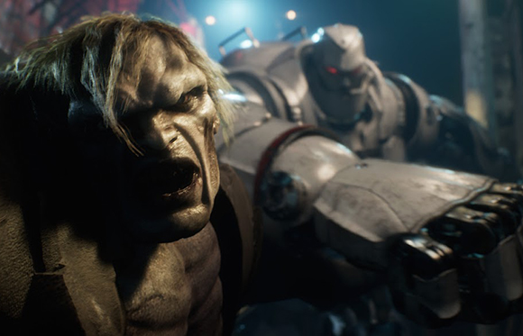 A grey-skinned creature with blonde hair grimaces in the foreground next to a large white armored robot.