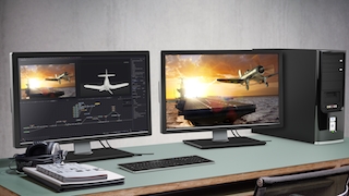 Two computer monitors on a desk displaying aircraft imagery next to a black desktop tower.