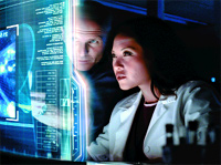 A man and a woman in lab coats study glowing blue data on a transparent digital screen.