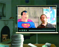 A projection screen shows an animated Superman next to a man with his mouth open in a room with a fireplace.