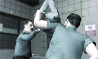 Three men in grey uniforms in a room with tiled walls.
