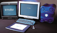 A computer setup with two monitors, a light blue keyboard, a digital tablet, and a blue rounded device.