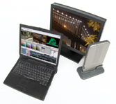 A black laptop, a computer monitor showing a bridge, and a tablet on a stand.