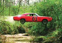 A red muscle car with the number 01 jumping over a creek in a wooded area.