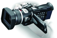 A person's hands holding a black professional video camera with a large lens hood.