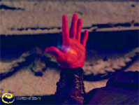 A hand glowing with intense red light is raised against a dark, textured background.